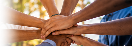 Young people working together with hands joined
